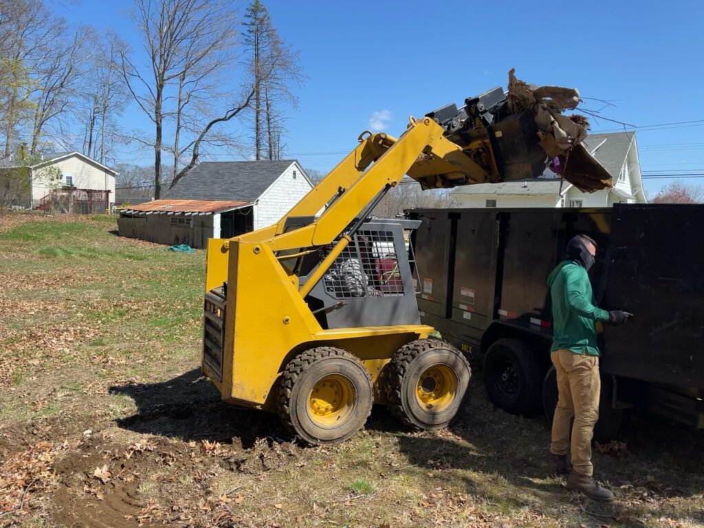 Barney loading junk in to trailer with skidsteer